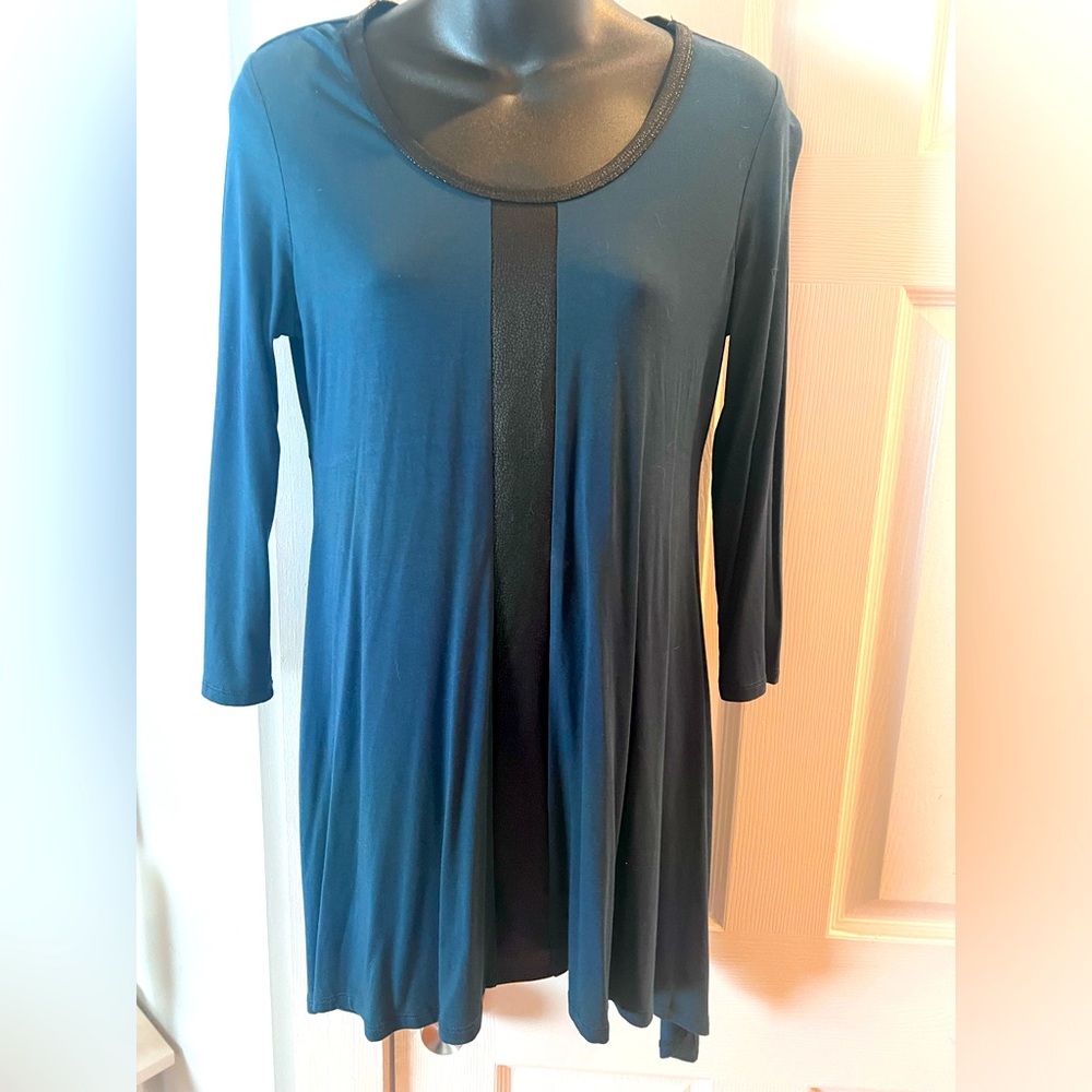 Beautiful shirt with black faux leather trim. Size small